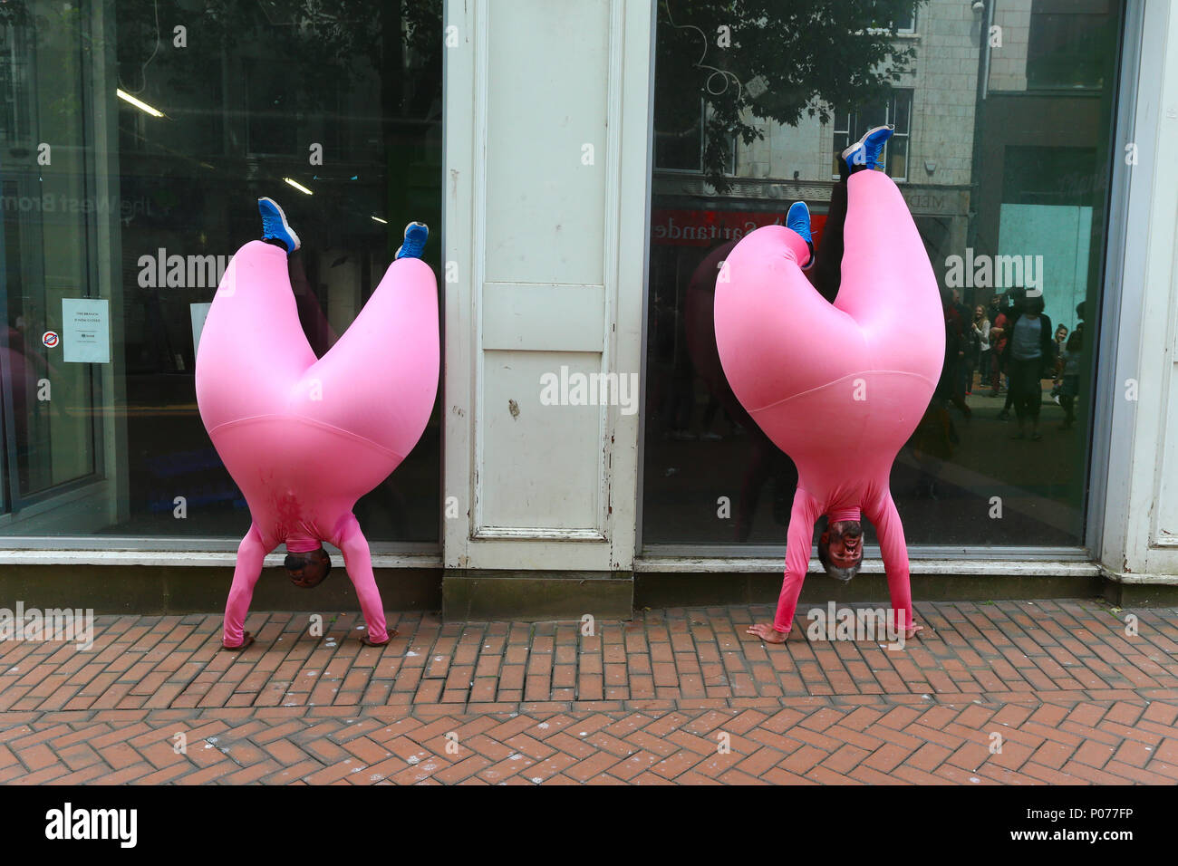 as-part-of-birmingham-international-dance-festival-the-french-dance-group-compagnie-didier-theron-perform-la-grande-phase-through-the-city-centre-of-birmingham-among-the-crowds-of-shoppers-the-dancers-wear-inflated-latex-costumes-to-enhance-the-feeling-of-weightlessness-and-to-magnify-their-balletic-movements-peter-lopemanalamy-live-news-P077FP.jpg